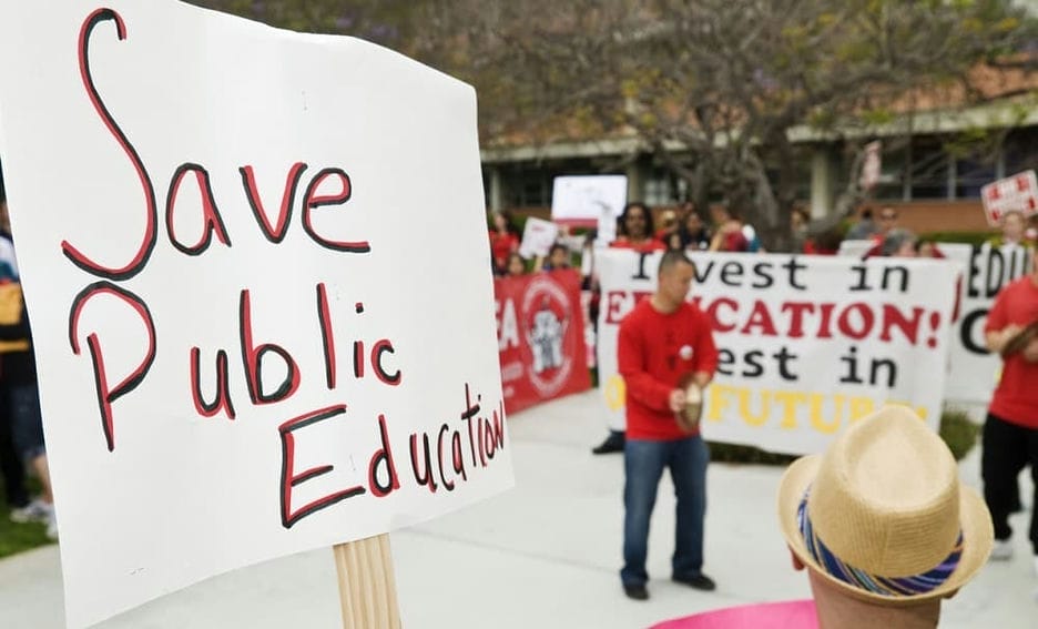 Protests in Arizona with sign saying 