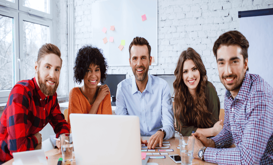 Diverse group of businesspeople surrounding conference table