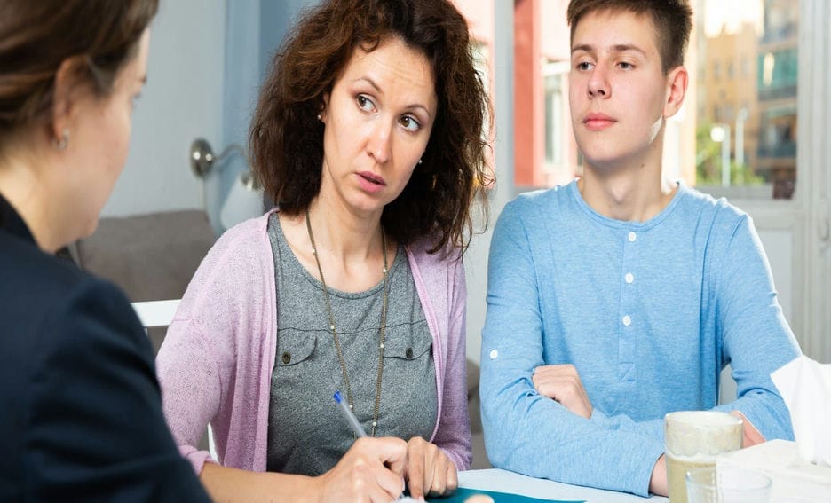 Mother and son meeting with a teacher