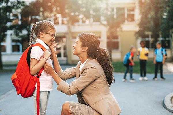 Parent says goodbye to child outside of school